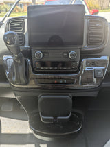 Interior of a modern RV rental dashboard, showing the touchscreen, climate controls, and gear shifter.