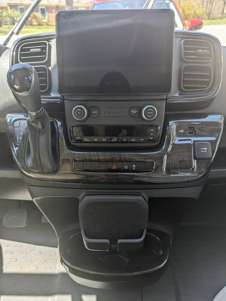 Interior of a modern RV rental dashboard, showing the touchscreen, climate controls, and gear shifter.