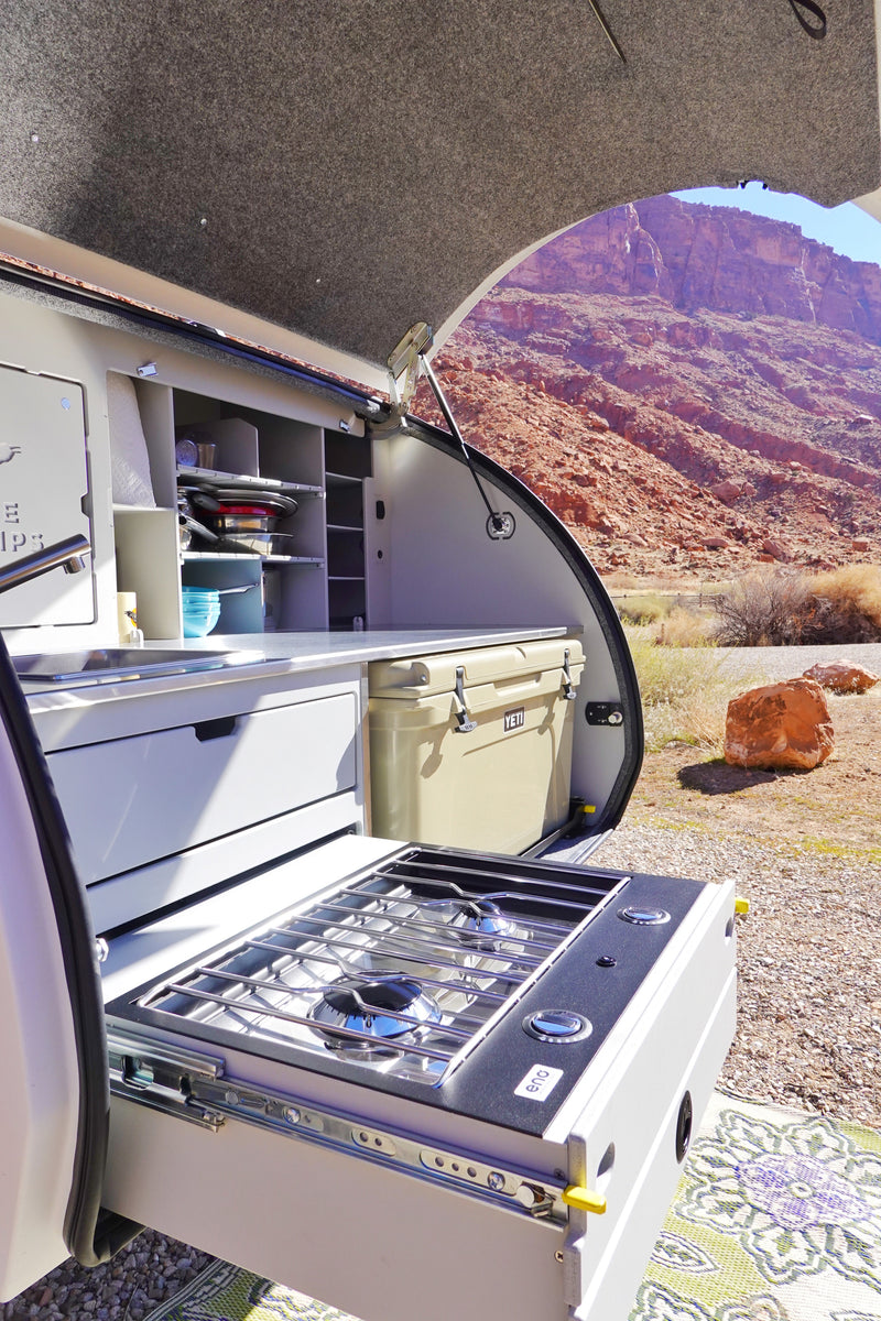 RV rental outdoor kitchen with pull-out stove, sink & cooler against desert mountains. — photo 12