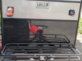 Back of a Hiker Trailer RV rental, featuring utility hookups, durable diamond plate, and a rear cargo rack.