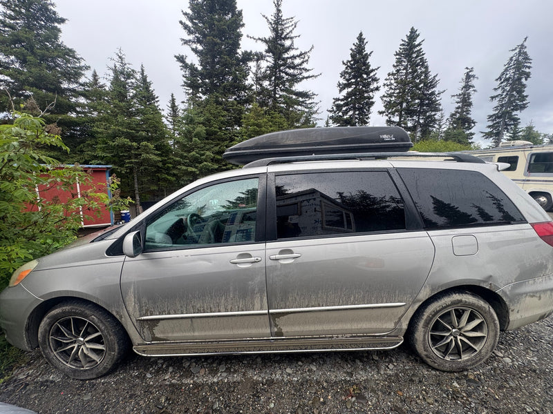  parked by trees on gravel. Perfect for a journey like an rv rental trip.|Cozy car camping bed (plaid) in SUV. View of an RV rental — photo 8