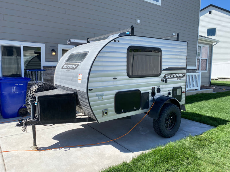  on a driveway. Perfect for your next rv rental camping adventure!|An RV rental's clever outdoor kitchen in a teardrop camper. It includes a sink — photo 1