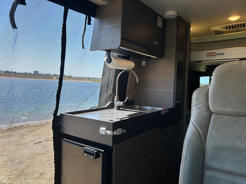  ideal for road trips and mobile living.|Inside an rv rental: a light-colored bed — photo 8