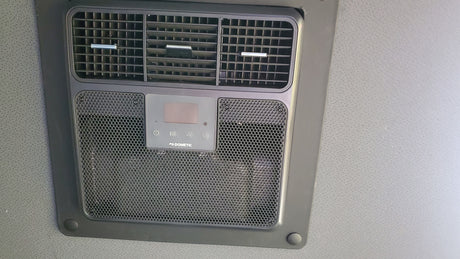 Overhead Dometic RV AC unit with vents and digital controls, ensuring comfort for your rv rental adventures.