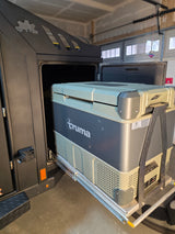 A Truma portable fridge/freezer, on a slide-out in an RV rental, provides convenient cold storage for camping adventures.