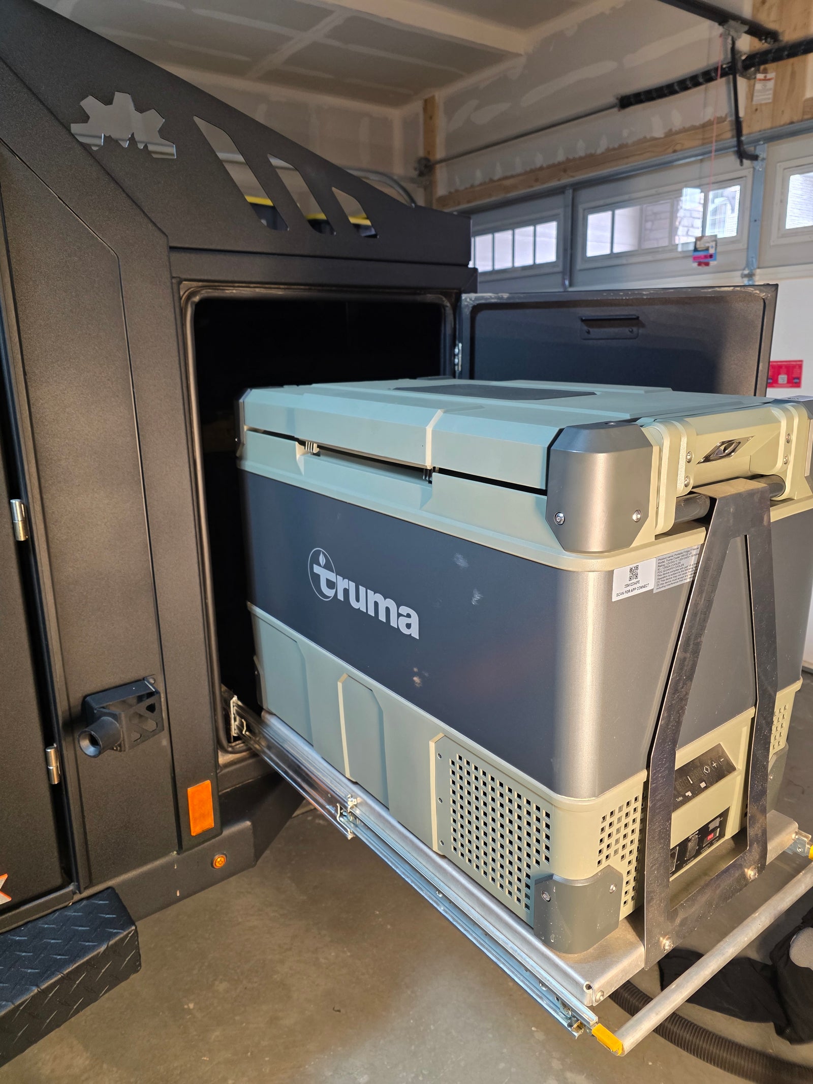 A Truma portable fridge/freezer, on a slide-out in an RV rental, provides convenient cold storage for camping adventures.