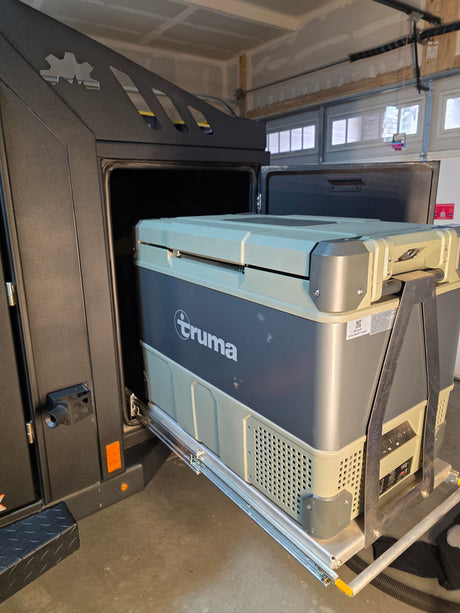 A Truma portable fridge/freezer, on a slide-out in an RV rental, provides convenient cold storage for camping adventures.