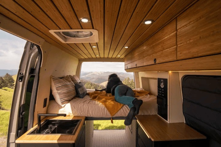 Escape to nature in this cozy rv rental. Enjoy mountain views from the bed of your custom camper van with a compact kitchen.