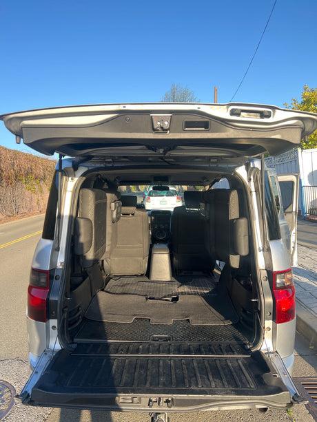 Spacious SUV interior with open tailgate, showcasing rear seats and cargo space. Perfect for your next RV rental trip.