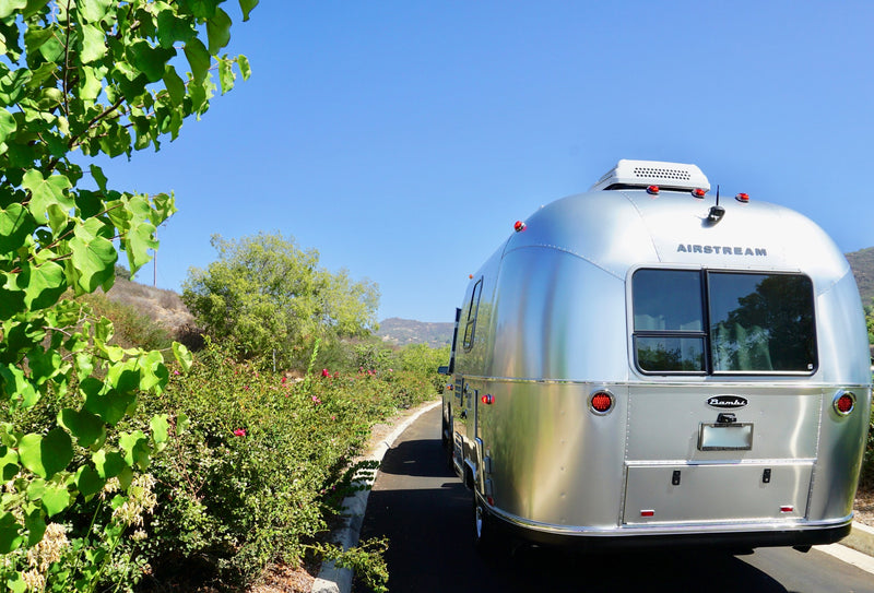 Rear view of a shiny Airstream Bambi travel trailer, perfect for your next RV rental adventure or camping trip. — photo 7