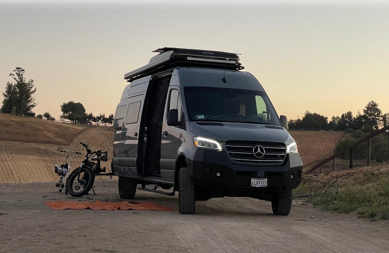 Dark gray Mercedes Sprinter rv rental camper van & bikes ready for adventure in a scenic rural setting at dusk. — photo 2
