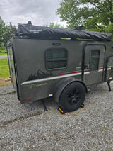 This rugged, dark gray Teardrop RV rental is ready for off-road camping and outdoor exploration.