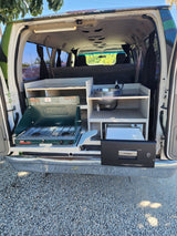 Explore with our RV rental camper van! Features a pull-out kitchen: Coleman stove, sink, and Dometic fridge.