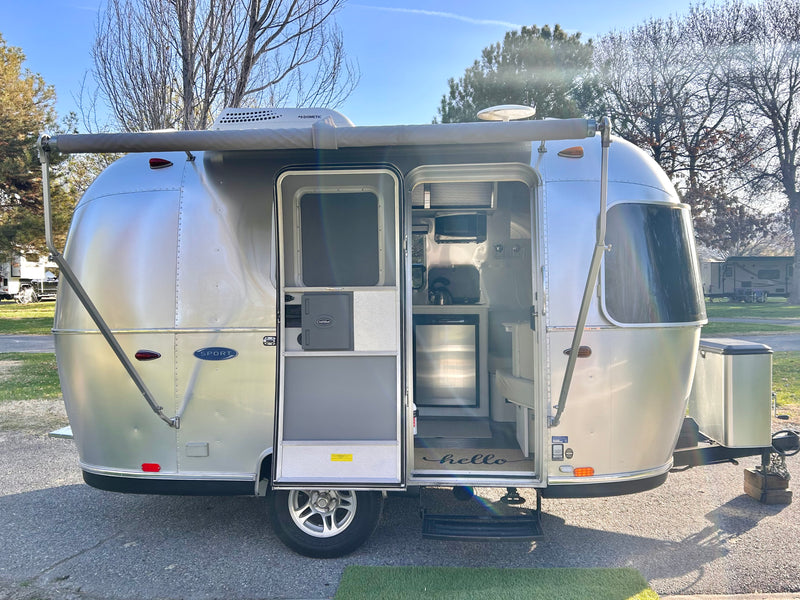 Open Airstream travel trailer for an rv rental, showcasing its inviting, compact interior for camping adventures. — photo 6