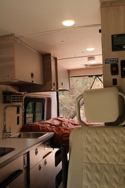  and an efficient wet bath with toilet and shower.|Dashboard and steering wheel of an RV rental — photo 12