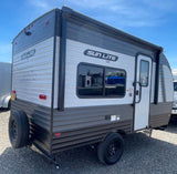  seen from the side on gravel. Features an awning. Ideal for rv rental adventures.|Compact Sun Lite LTD travel trailer