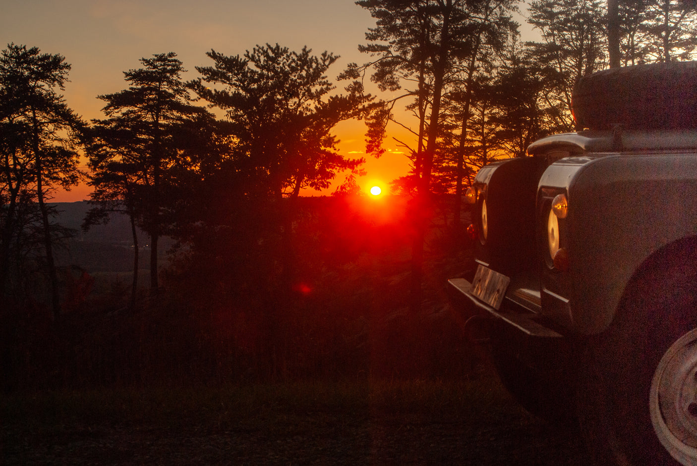 Vibrant sunset view from a classic 4x4 vehicle, embodying the spirit of an RV rental adventure.