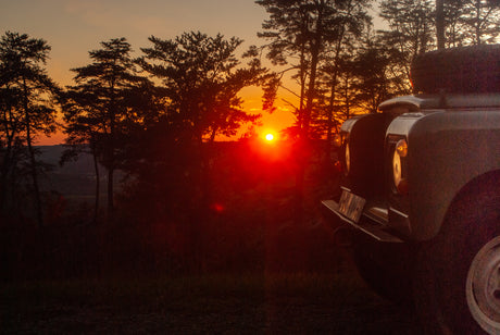 Vibrant sunset view from a classic 4x4 vehicle, embodying the spirit of an RV rental adventure.