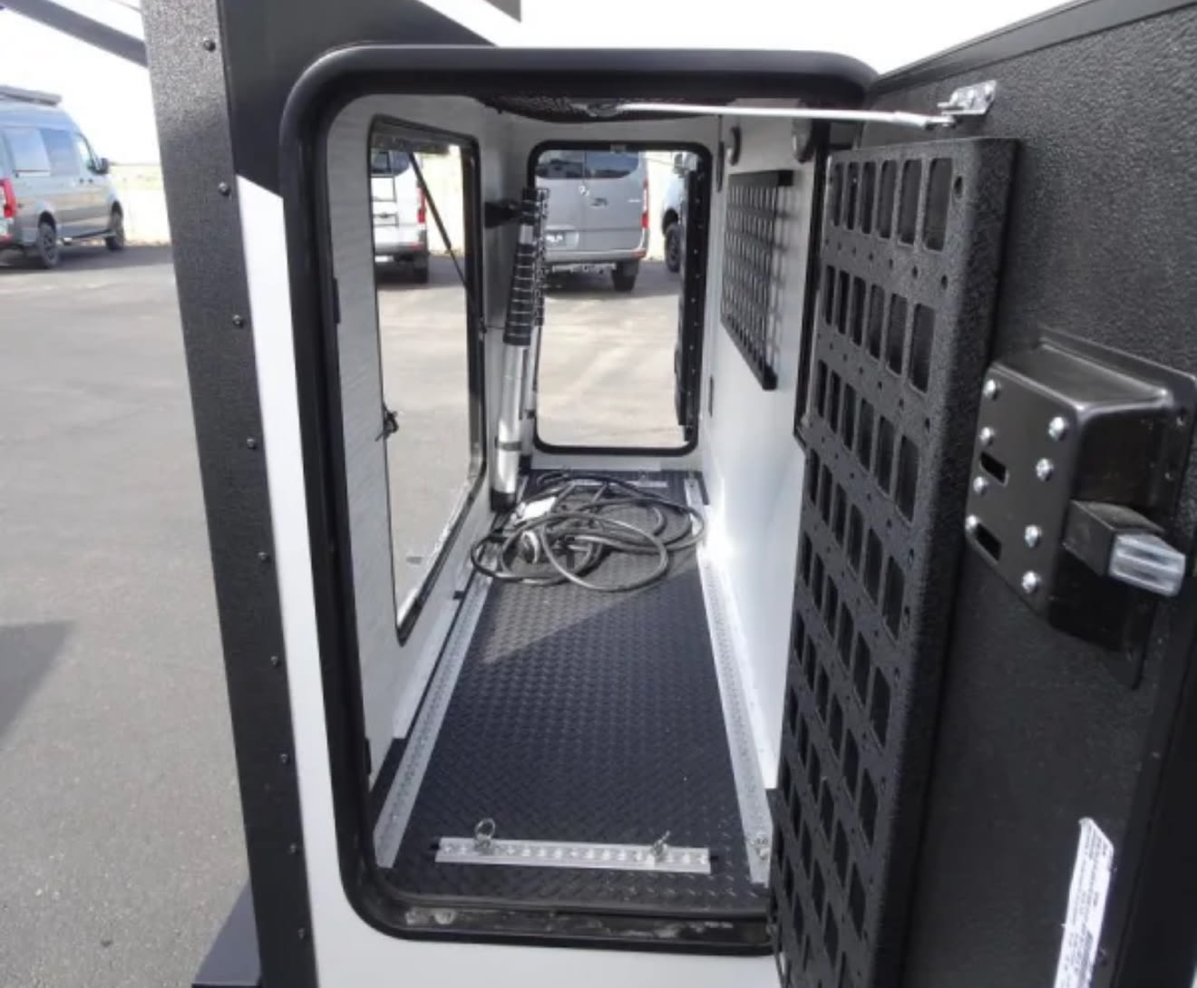  and a fire extinguisher.|RV rental interior: Looking in from the entry step at a light-toned dinette — photo 12