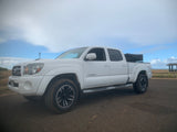White Toyota Tacoma pickup, great for RV rental coastal adventures and camping by the beach.