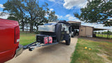 Red pickup truck hitched to an off-road camper, featuring solar and generator, ready for your RV rental adventure.