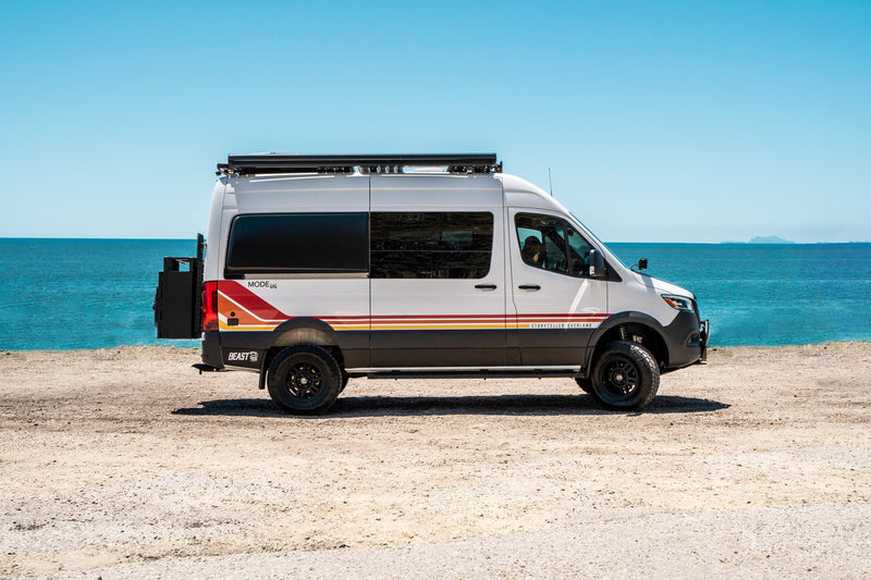 White Storyteller Overland camper van by the ocean, ideal for an RV rental or overland adventure. — photo 1