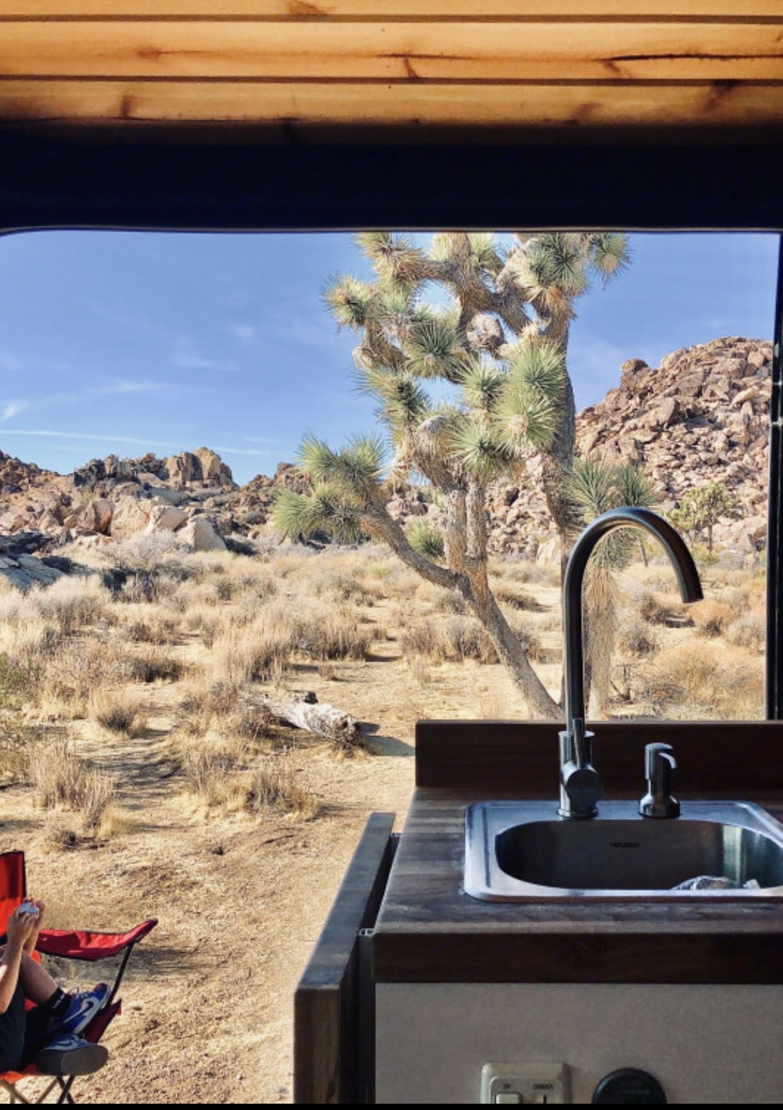  and a versatile collapsible cutting board.|Spacious RV rental interior with a cozy wooden plank ceiling — photo 16