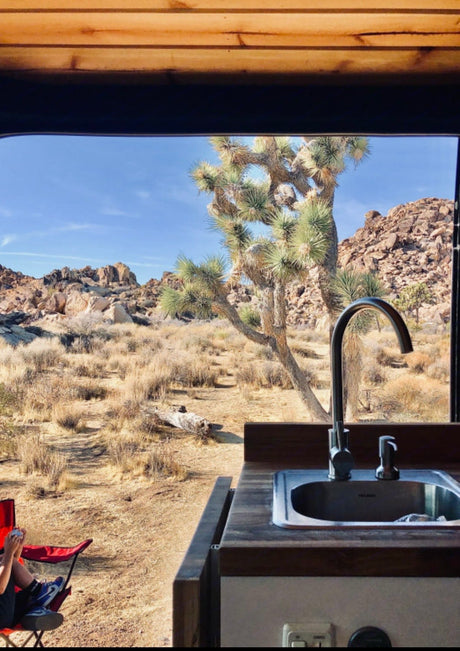  and a versatile collapsible cutting board.|Spacious RV rental interior with a cozy wooden plank ceiling