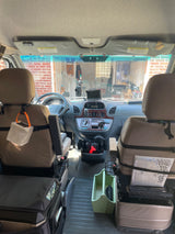 RV rental interior: Organized cockpit with dashboard, comfy seats, navigation, and storage for road trips.