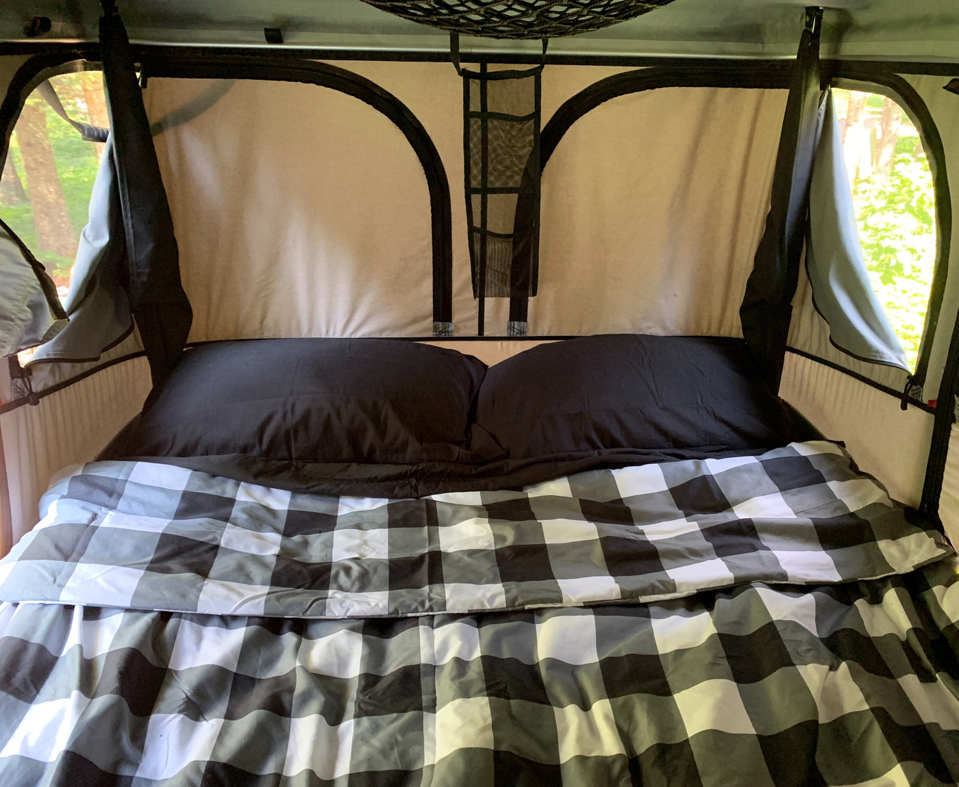  drives on a scenic road.|A happy child smiles from a rooftop tent — photo 4
