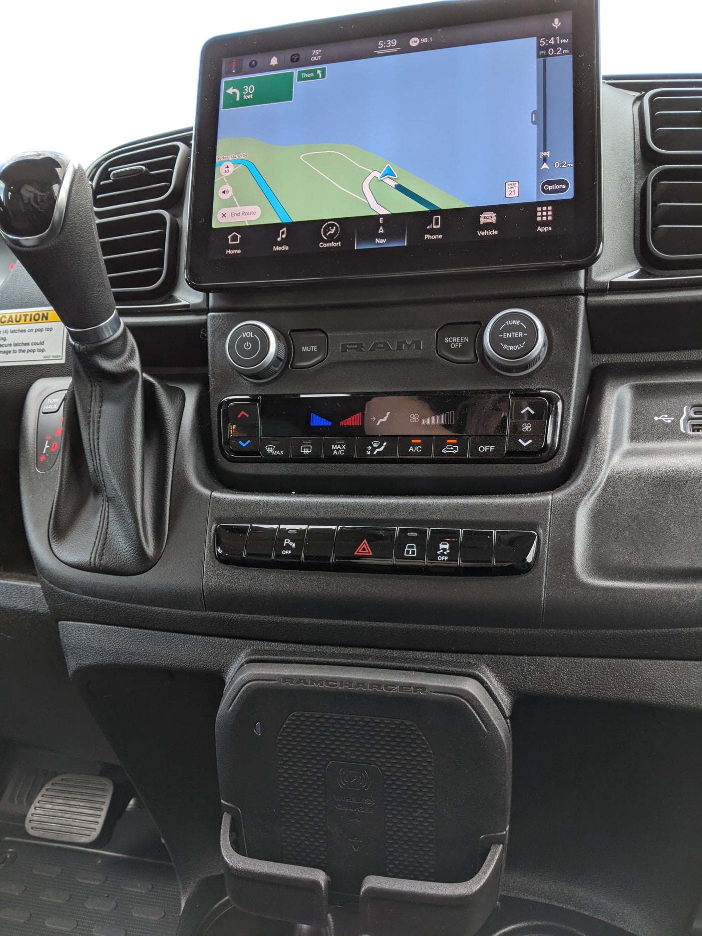 RV rental dashboard with active navigation, climate controls, and wireless charger, showcasing modern vehicle tech.