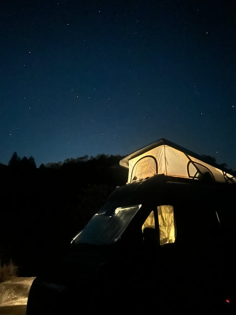 Stargaze from your RV rental's illuminated pop-up tent under a clear, star-filled night sky. Perfect night camping adventure!
