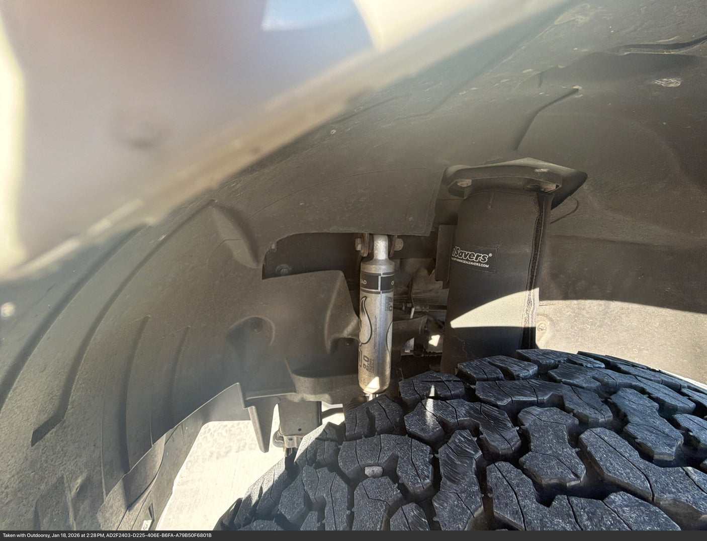 An RV rental's rugged off-road tire & robust Fox 2.0 suspension with SealSavers. View from inside the wheel well.