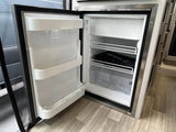 Open RV rental refrigerator, featuring clean shelves, door storage, and a top freezer compartment for your journey.