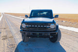 Black Ford Bronco on a snowy dirt road. Explore the outdoors! Plan your adventure, from off-roading to an RV rental.
