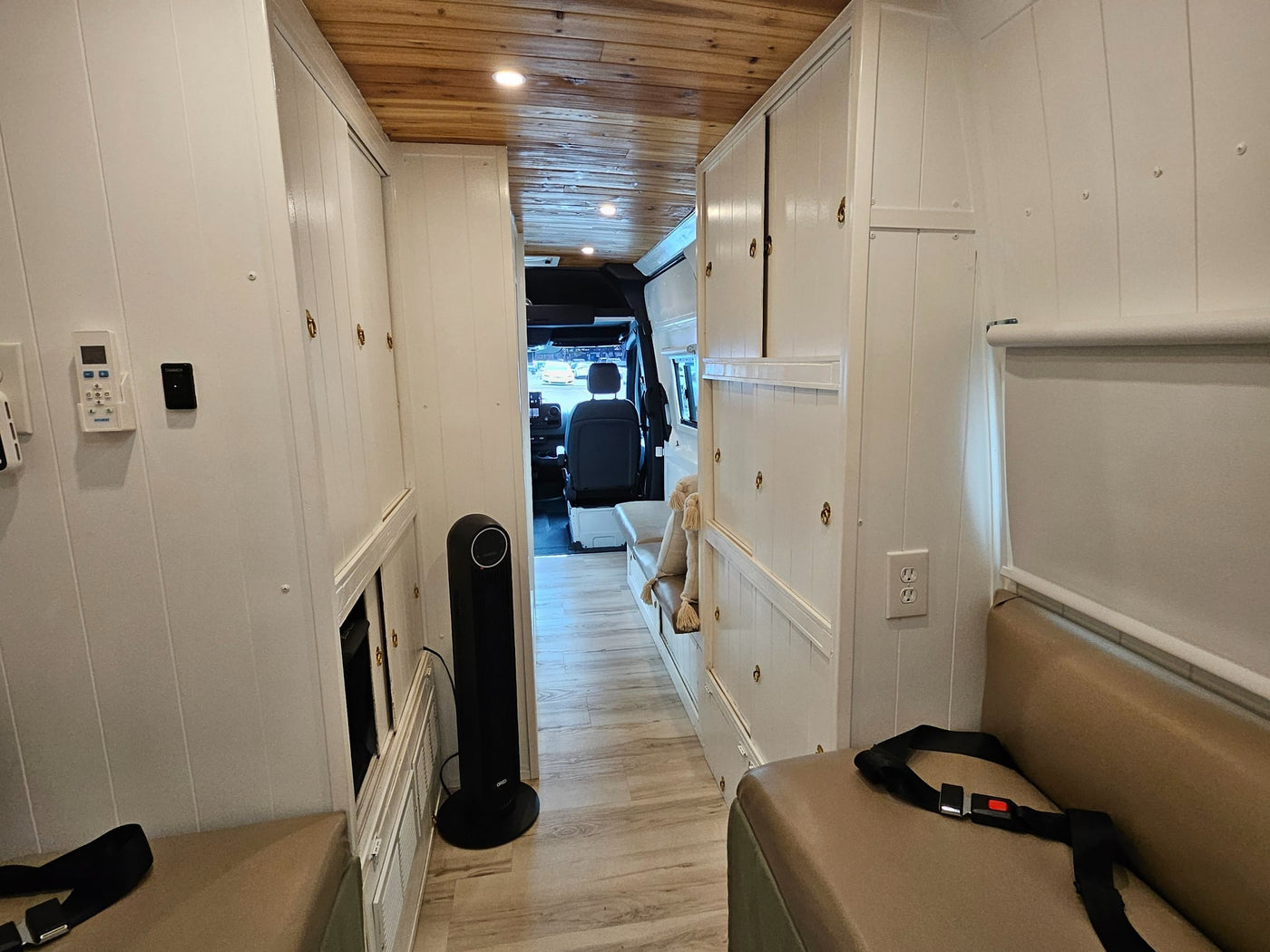  and a toilet with bidet and toilet paper holder on the right.|A compact RV rental bedroom with a bed featuring a green and white patterned quilt — photo 8