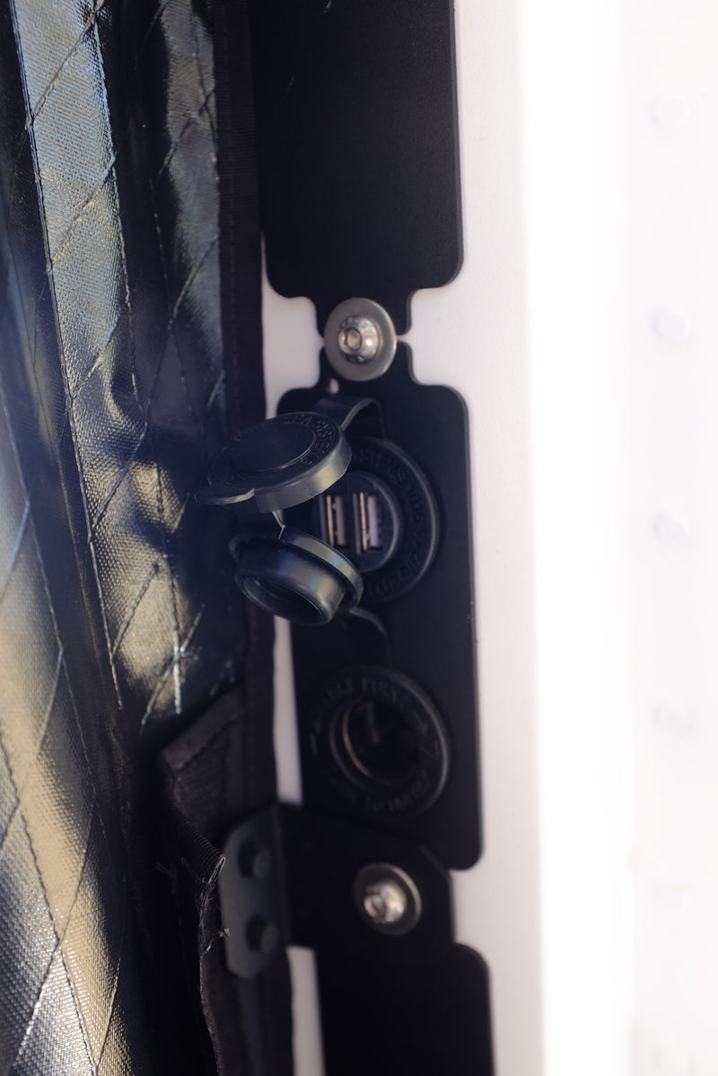 Stay powered up in your rv rental! Close-up of dual USB charging ports and a 12V socket for essential mobile charging. — photo 11