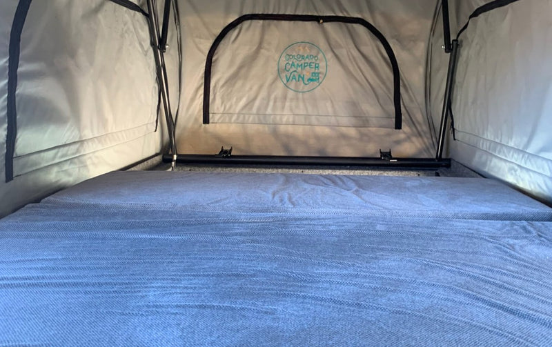  parked in a scenic outdoor setting.|Inside an RV rental: two grey passenger seats with seatbelts — photo 4