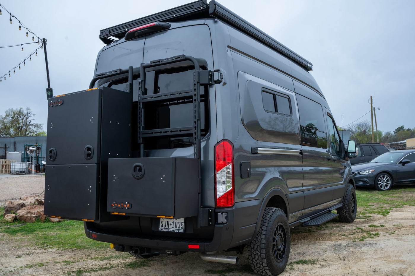  equipped with a roof rack and ladder. Ideal for RV rental.|Gray Ford Transit rv rental van with roof rack — photo 6