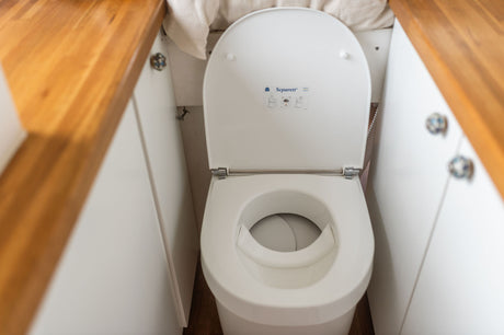 Sustainable living in an RV rental: a clean Separett composting toilet with wood accents. Ideal for compact off-grid travel.