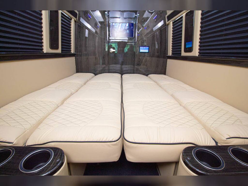 amidst green trees.|Inside a modern rv rental: cream quilted leather seats — photo 1
