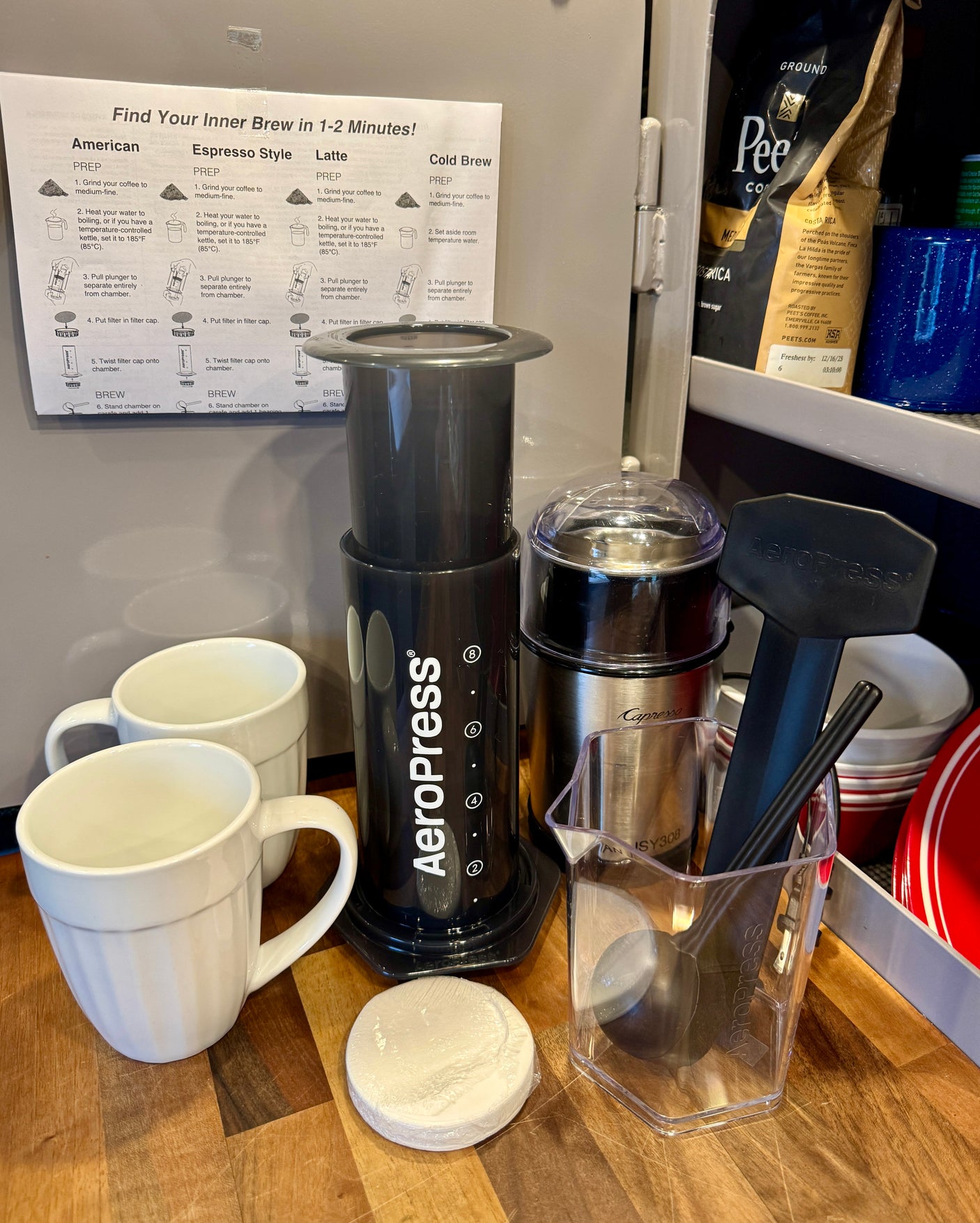 AeroPress coffee setup with "Find Your Inner Brew" instructions & grinder, perfect for an rv rental.