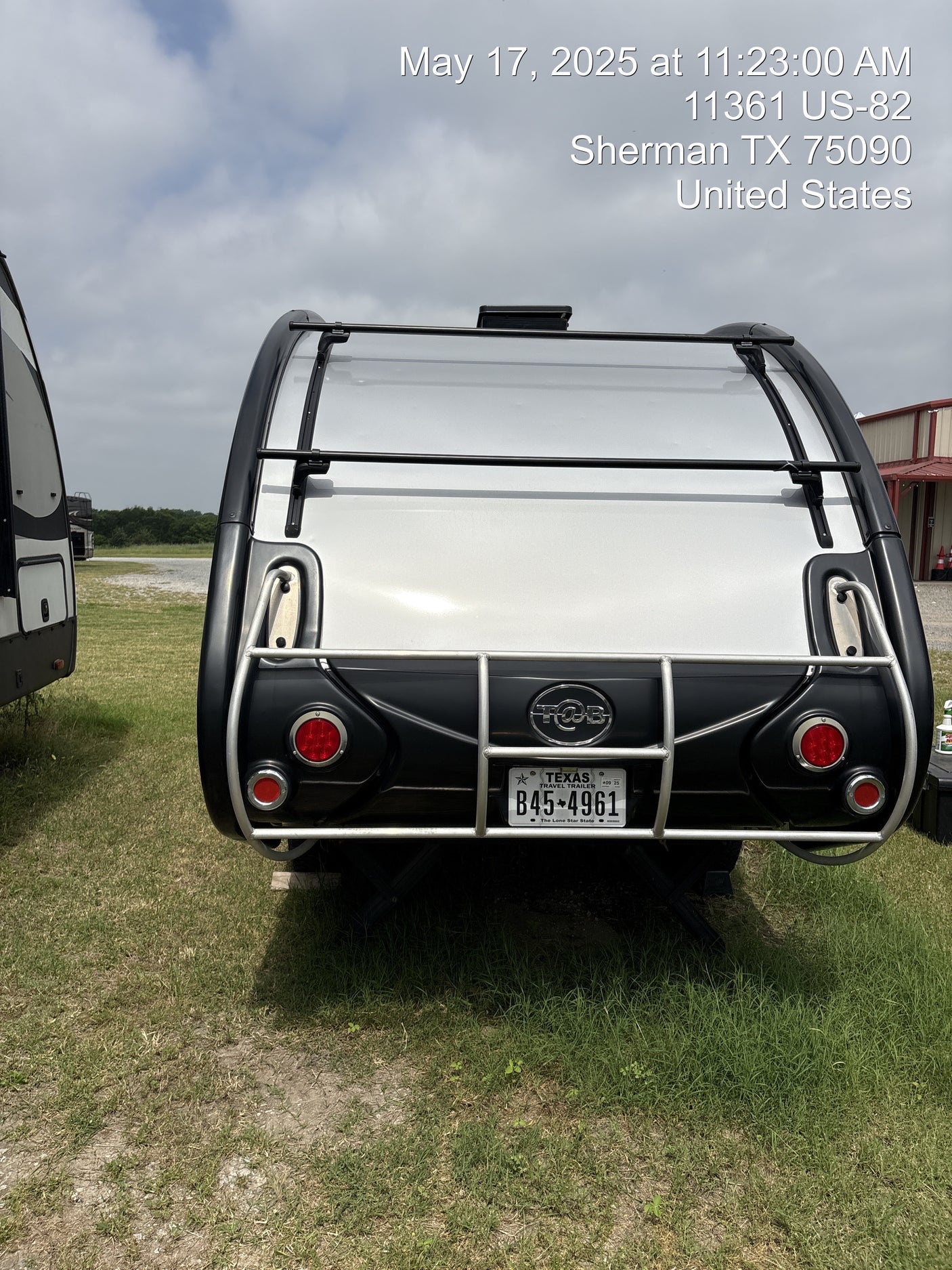 Rear view of a T@B travel trailer, a great RV rental option, with Texas plate B45-4961. Photo taken May 17, 2025.