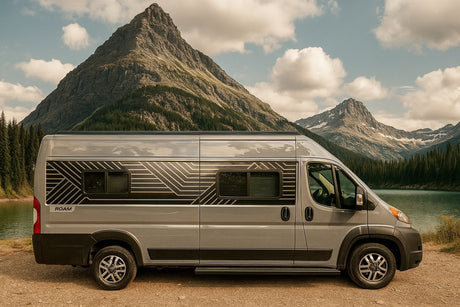 Gray ROAM rv rental camper van by a serene mountain lake, surrounded by majestic peaks and evergreen trees.