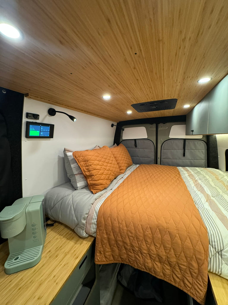  colorful sky.|Experience a modern RV rental interior with a cozy bed — photo 7
