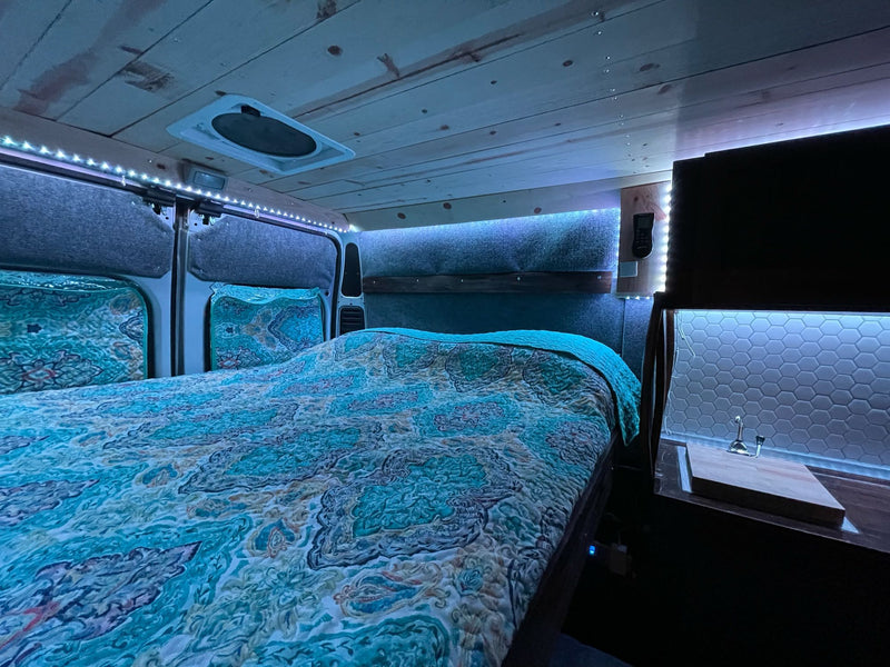  and front seats with a built-in table.|Sleek RV rental kitchenette: hexagonal tiled backsplash — photo 5