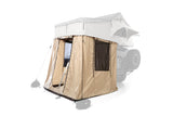 A tan vehicle rooftop tent with an attached ground annex provides extra enclosed space for camping. Ideal for RV rental alternative.