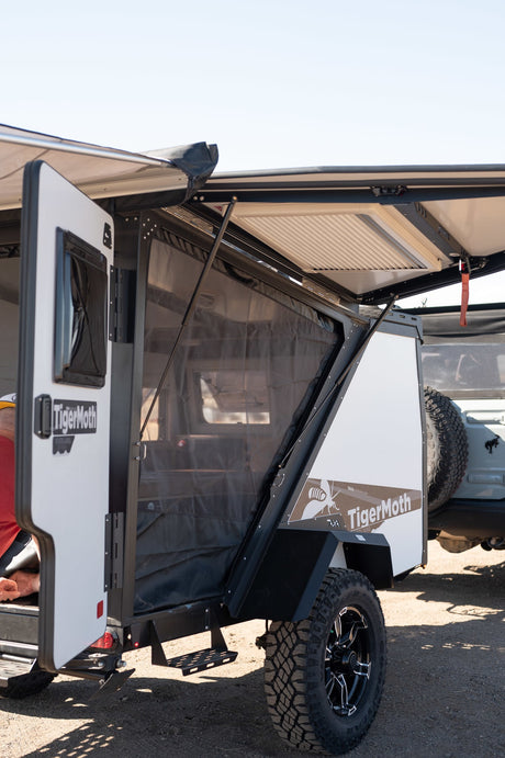 TigerMoth off-road trailer for RV rental. Experience camping adventure with its open awning and mesh side.
