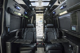 Plush black leather seating and modern amenities fill this spacious rv rental interior, ideal for travel comfort.