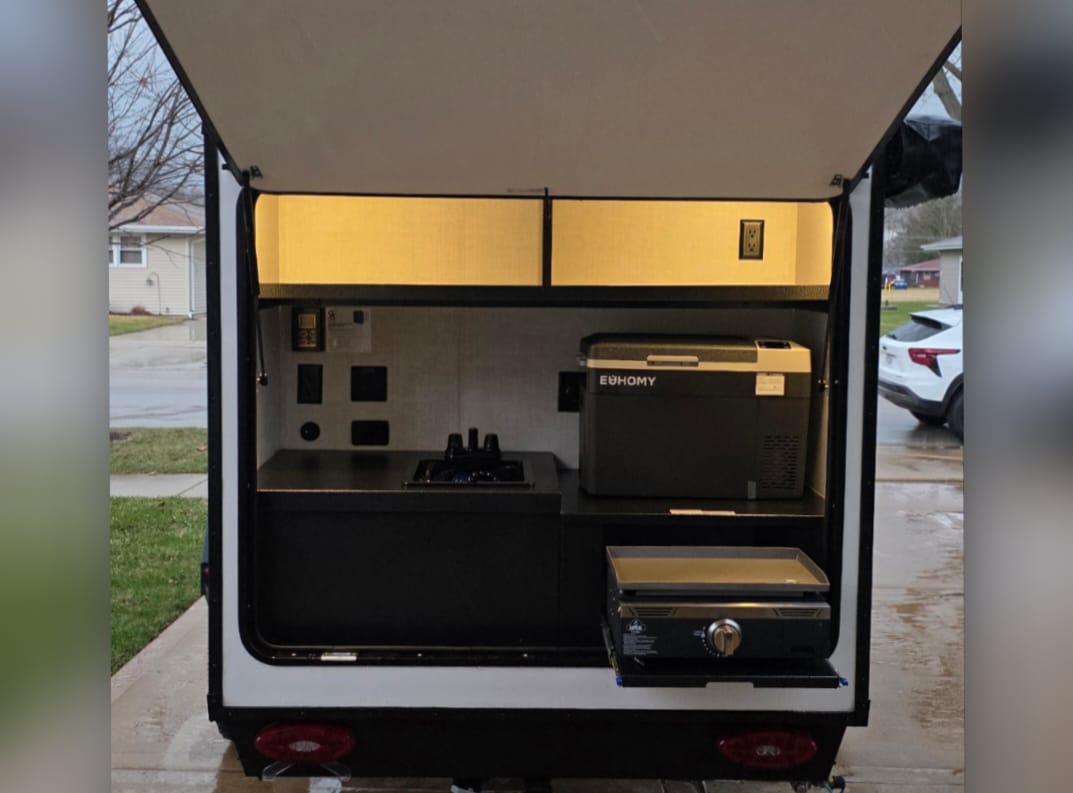 RV rental outdoor kitchen: sink, Euhomy fridge, pull-out griddle. Compact setup for camping adventures. — photo 14